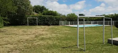 a swimming pool with two goal nets in a yard at Alquiler temporal casa Bialet Masse con pileta, cancha de fútbol, mesa de pool y ping pong in Bialet Massé
