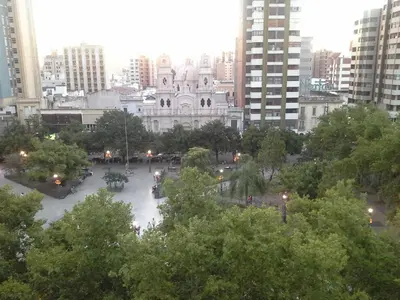 a view of a building in a city with trees at Grand Hotel Rio Cuarto in Río Cuarto