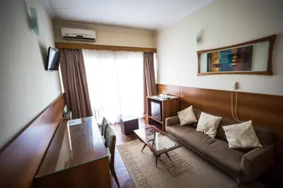 a living room with a couch and a window at Grand Hotel Rio Cuarto in Río Cuarto
