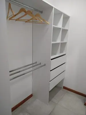a white walk in closet with white shelves at Aparts Kodu- Residencia Familiar in Río Cuarto