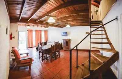 a kitchen and dining room with a wooden ceiling at La Candida departamentos in Merlo