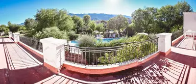 a walkway with a fence and a swimming pool at La Candida departamentos in Merlo