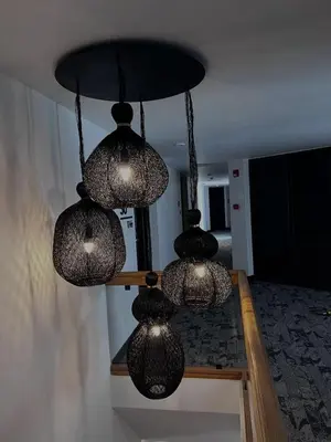 a group of lights hanging from a ceiling at THE HOTEL in Cordoba