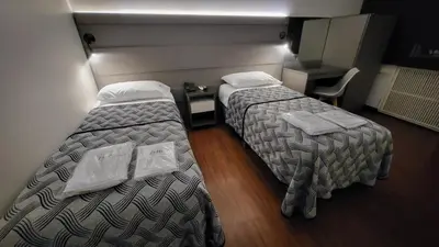 a hotel room with two beds and a desk at THE HOTEL in Cordoba