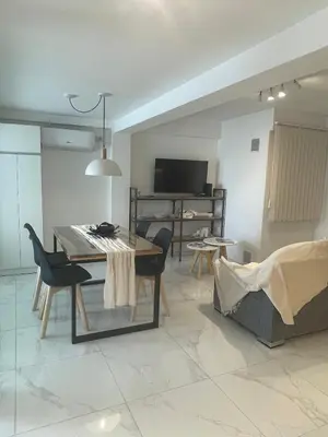 a dining room and living room with a table and chairs at DEPARTAMENTO CENTRICO CON COCHERA - CORDOBA Argentina- in Cordoba