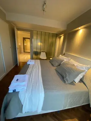 a bedroom with a large bed with two pillows at DEPARTAMENTO CENTRICO CON COCHERA - CORDOBA Argentina- in Cordoba