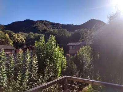 a view of a mountain with trees and a house at Balcón de la montaña in Santa Rosa de Calamuchita