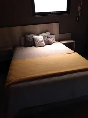 a large bed in a room with a window at Balcón de la montaña in Santa Rosa de Calamuchita