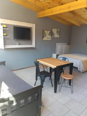 a room with a table and chairs and a bed at Balcón de la montaña in Santa Rosa de Calamuchita
