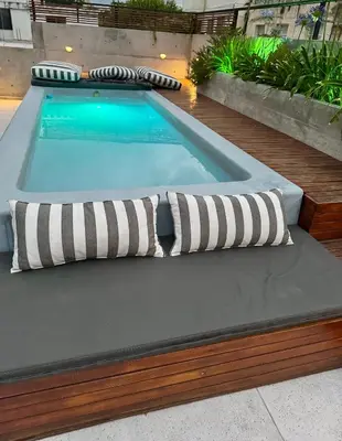 a swimming pool with two pillows on top of it at Loft 2023 in Villa Carlos Paz
