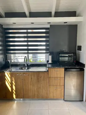 a kitchen with a sink and a microwave at Loft 2023 in Villa Carlos Paz