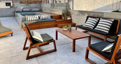 a patio with chairs and a bench and a hot tub at Loft 2023 in Villa Carlos Paz