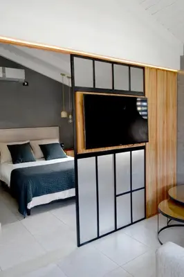 a bedroom with a bed and a large window at Loft 2023 in Villa Carlos Paz