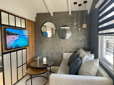 a living room with a couch and a table at Loft 2023 in Villa Carlos Paz