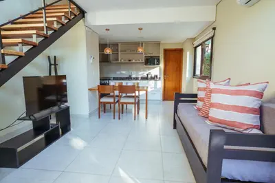 a living room and kitchen with a couch and a table at El Nogal Apart Hotel in Villa General Belgrano