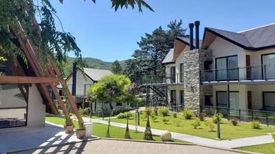 a row of houses with a garden in front at El Nogal Apart Hotel in Villa General Belgrano