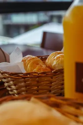 a basket of bread sitting on a table at El Nogal Apart Hotel in Villa General Belgrano