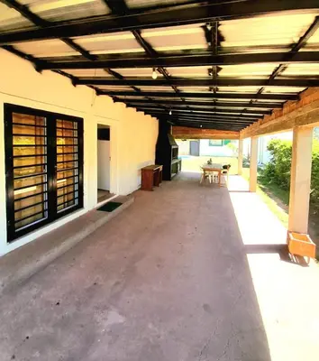 an empty patio of a building with awning and a table at Casa el sueño de Alicia in Villa del Dique