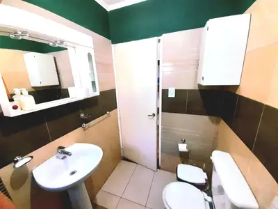 a bathroom with two toilets and a sink at Casa el sueño de Alicia in Villa del Dique