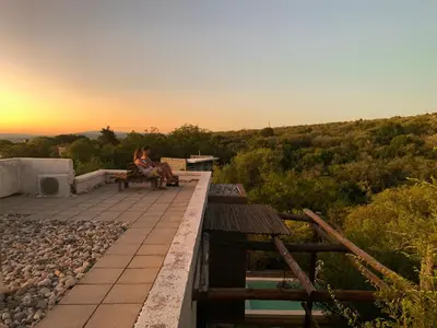 a woman sitting on a bench watching the sunset at La Molicie, Achiras Arriba in San Javier