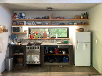 a small kitchen with a stove and a refrigerator at La Molicie, Achiras Arriba in San Javier