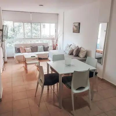a living room with a couch and a table and chairs at Departamento en la mejor zona de GENERAL PAZ in Cordoba