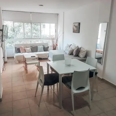 a living room with a table and chairs and a couch at Departamento en la mejor zona de GENERAL PAZ in Cordoba