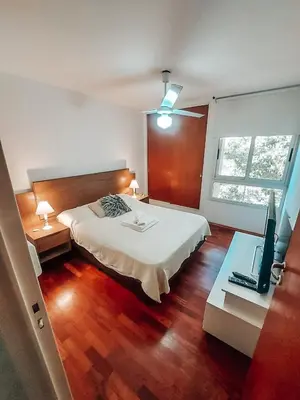 a bedroom with a bed and a desk with a television at Departamento en la mejor zona de GENERAL PAZ in Cordoba