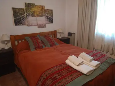 a bedroom with a bed with two towels on it at Herencia Nativa in Villa Yacanto