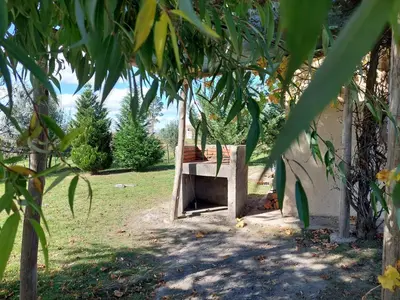 a wooden shelter in the yard of a house at Herencia Nativa in Villa Yacanto