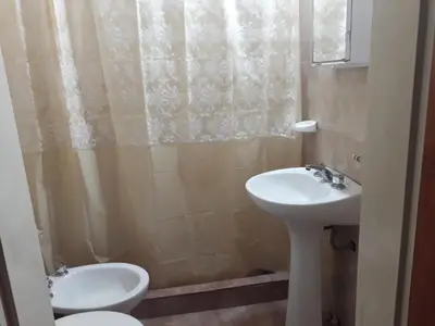 a bathroom with a toilet and a sink at Herencia Nativa in Villa Yacanto