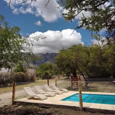 a group of lounge chairs next to a swimming pool at MORADA DEL ZORRO in Merlo