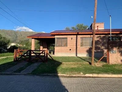 a house with a fence and a gate in front of it at MORADA DEL ZORRO in Merlo