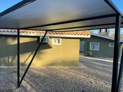 awning over a building in front of a house at CasitaLiu in Villa General Belgrano