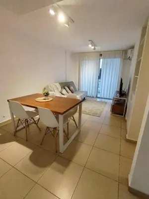 a living room with a table and chairs and a couch at Departamento Boho Chic Corazón de Nueva Córdoba in Cordoba