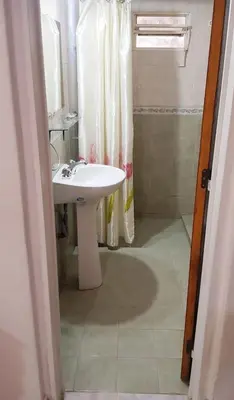 a bathroom with a white sink and a shower at Lo de Liliana in Tanti