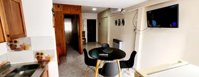 a small kitchen with a black table and chairs at Lo de Liliana in Tanti