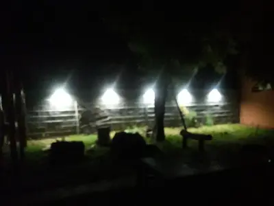 a park at night with lights in the background at Cabañas Don Pocho in Villa Cura Brochero