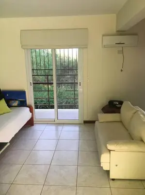 a living room with a couch and a large window at Arcángeles del Oeste - Descanso al pie de la montaña in La Población