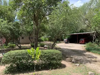 a house with a car parked in a yard at Arcángeles del Oeste - Descanso al pie de la montaña in La Población