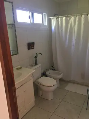 a bathroom with a toilet and a sink and a mirror at Arcángeles del Oeste - Descanso al pie de la montaña in La Población