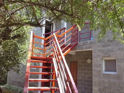 an orange staircase leading up to a building at Arcángeles del Oeste - Descanso al pie de la montaña in La Población