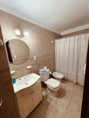 a bathroom with a sink and a toilet and a mirror at LitStay - Departamento con Cochera Barrio General Paz in Cordoba