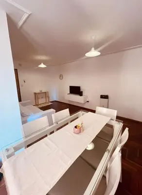 a living room with a table and chairs and a couch at LitStay - Departamento con Cochera Barrio General Paz in Cordoba