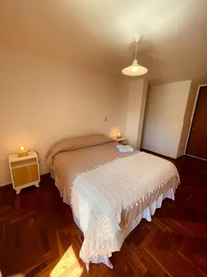 a bedroom with a large white bed with two lights at LitStay - Departamento con Cochera Barrio General Paz in Cordoba