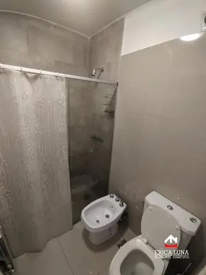 a bathroom with a toilet and a shower and a sink at Departamento centrico Carlos Paz in Villa Carlos Paz