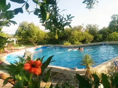 a person swimming in a swimming pool at Pachamama cabañas en la montaña in Mina Clavero