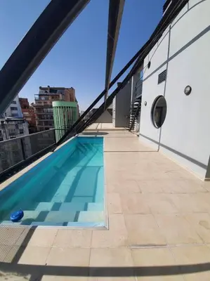 a swimming pool on the roof of a building at LOCADOR Nueva Cordoba 5B in Cordoba