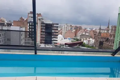 a view of a city skyline from a swimming pool at LOCADOR Nueva Cordoba 5B in Cordoba