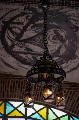 a chandelier hanging from a ceiling with a stained glass window at Terra Firma Hotel Boutique in Villa Carlos Paz
